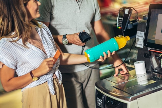 Independent grocery store self-checkout kiosk showing POS self-checkout system with integrated inventory tracking labor cost reduction and shopper experience improvements
