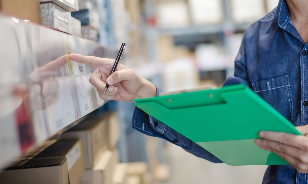 Independent grocery store manager reviewing real-time inventory reorder alerts and supplier purchase order history in FlexRetail back-office management dashboard