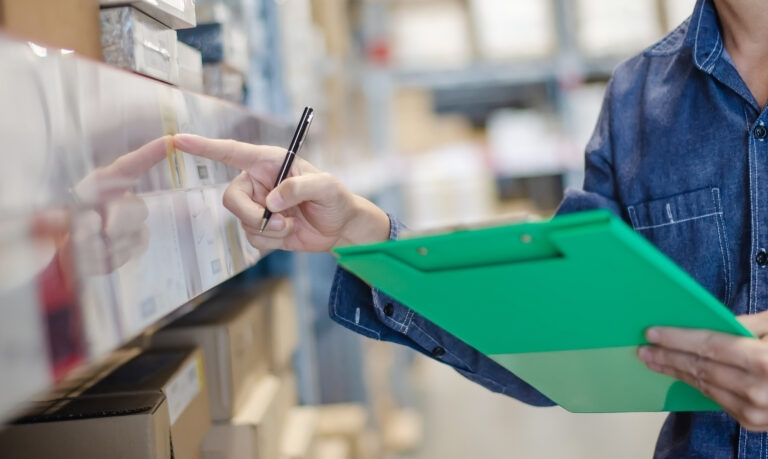 Independent grocery store manager reviewing real-time inventory reorder alerts and supplier purchase order history in FlexRetail back-office management dashboard