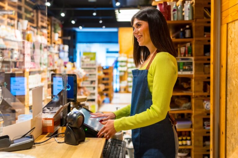 New grocery store employee learning a POS system quickly during onboarding at an independent grocery store