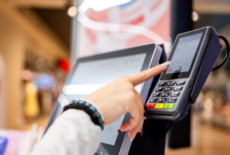 Independent grocery store owner reviewing customer loyalty profiles and personalized promotion data in FlexRetail POS platform to meet shopper expectations in 2026