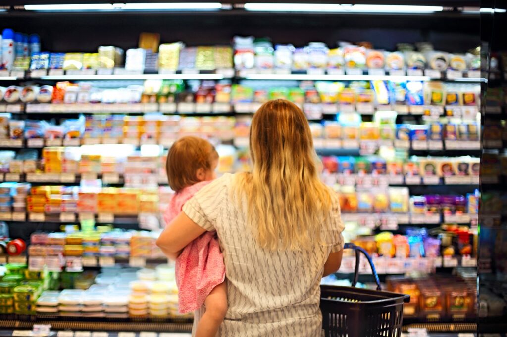 WIC participant using an eWIC card at a certified independent grocery store POS terminal