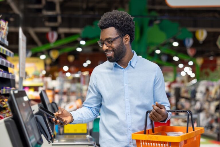 Independent grocery store manager evaluating an aging POS terminal for replacement
