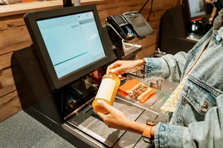 customer-facing checkout display showing real-time item prices and loyalty discounts at a grocery register