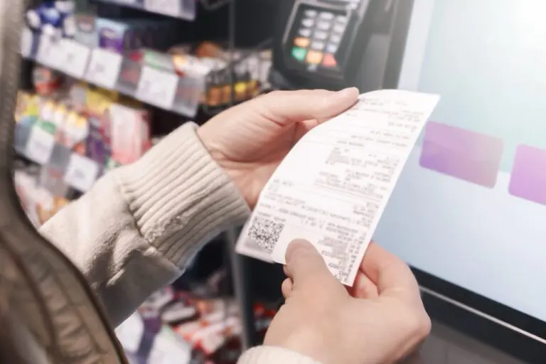 grocery cashier processing an OTC benefit card payment for eligible health products at checkout