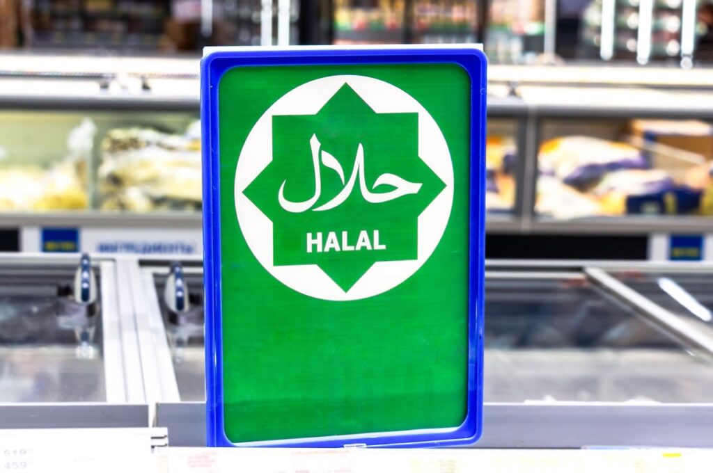 Halal market checkout counter displaying certified product labels and POS terminal