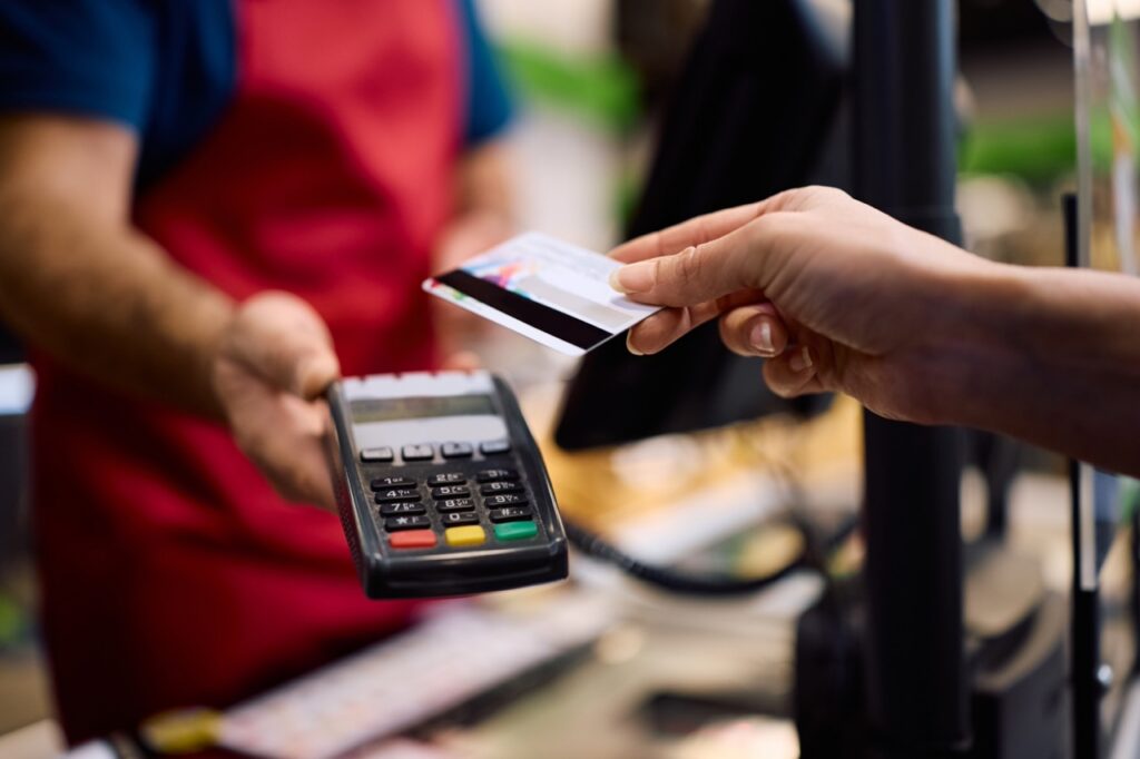 Grocery store owner reviewing a breakdown of card payment processing fees