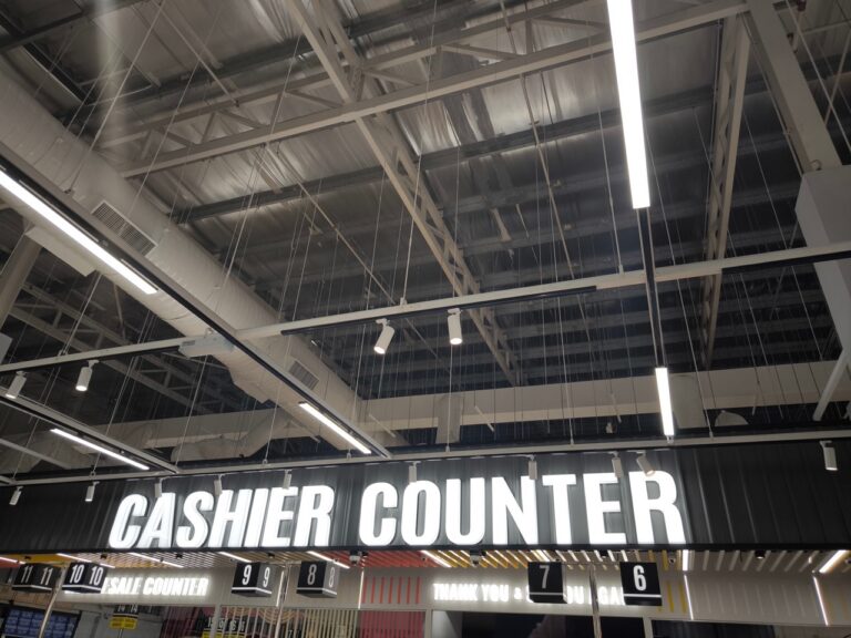 Cashier processing a fast, smooth checkout transaction at a grocery lane