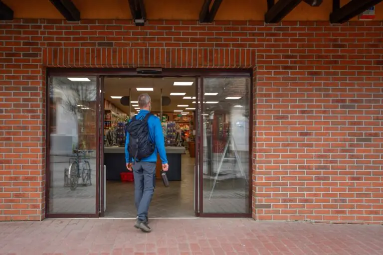 Shopper browsing a fresh produce display at the entrance of an independent grocery store