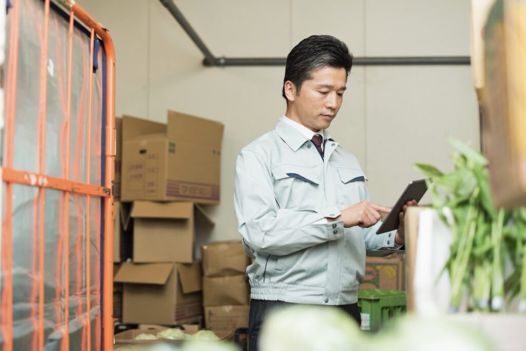 Grocery store manager retrieving a digital vendor invoice from a paperless back office system