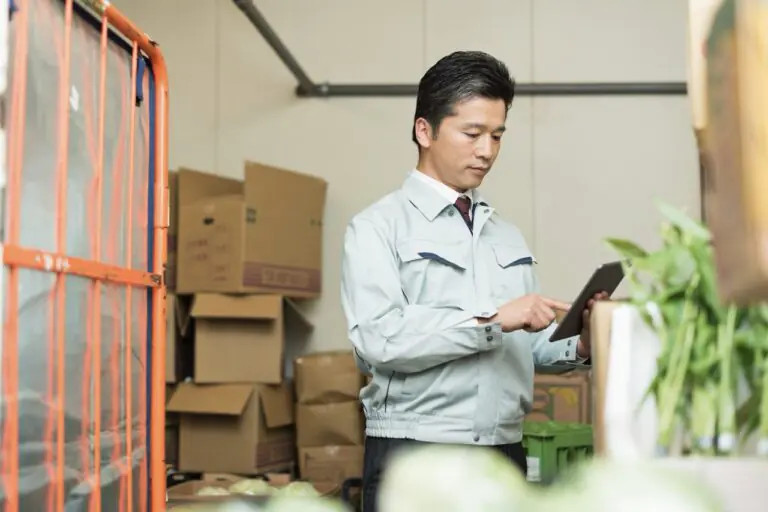 Grocery store manager retrieving a digital vendor invoice from a paperless back office system