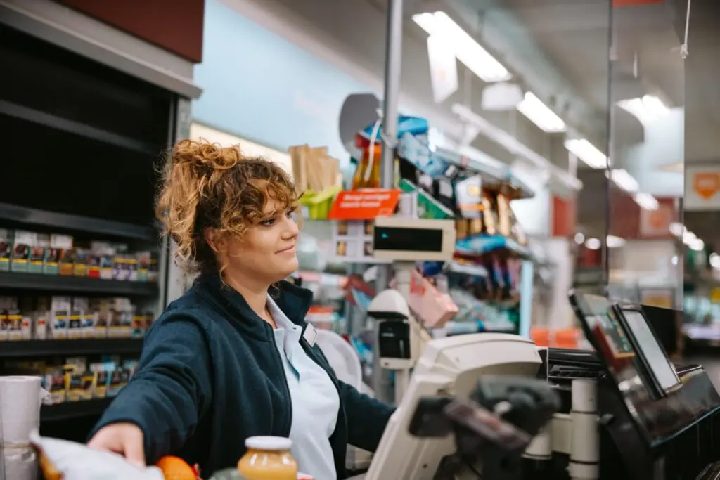 Grocery store manager reviewing EBT transaction reports for SNAP compliance