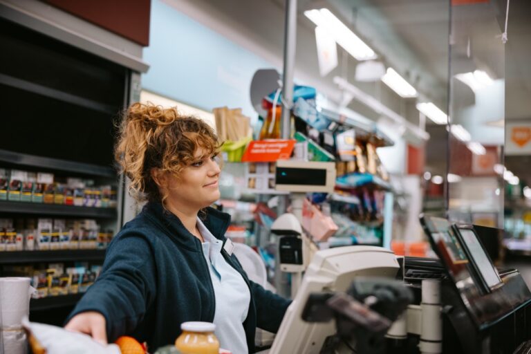 Grocery store manager reviewing EBT transaction reports for SNAP compliance
