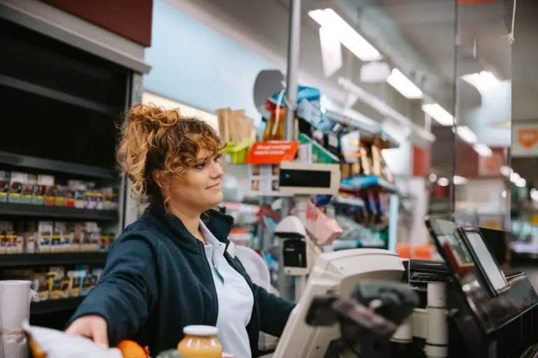 Grocery store manager reviewing EBT transaction reports for SNAP compliance