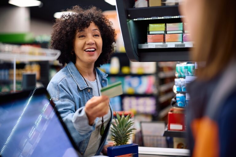 Grocery cashier processing an EBT split tender transaction at the register