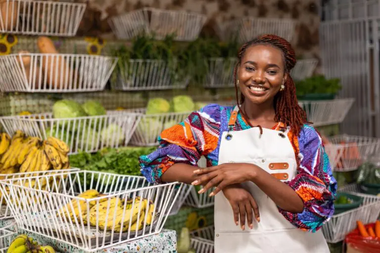 Caribbean grocery store cashier weighing produce at a grocery POS station